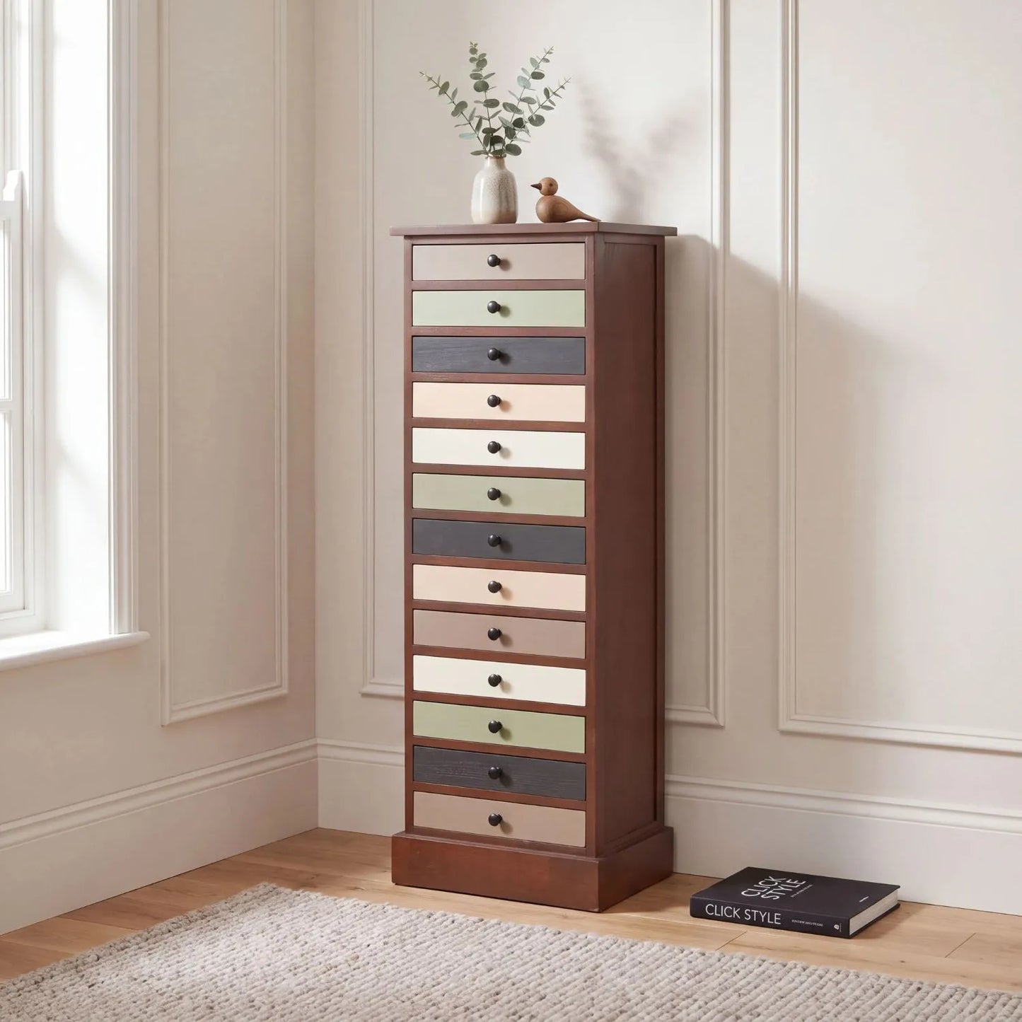 Sage Green & Neutral Pine Wood 13 Drawer Tallboy Chest with Black Knob Handles styled in a neutral interior | Click Style