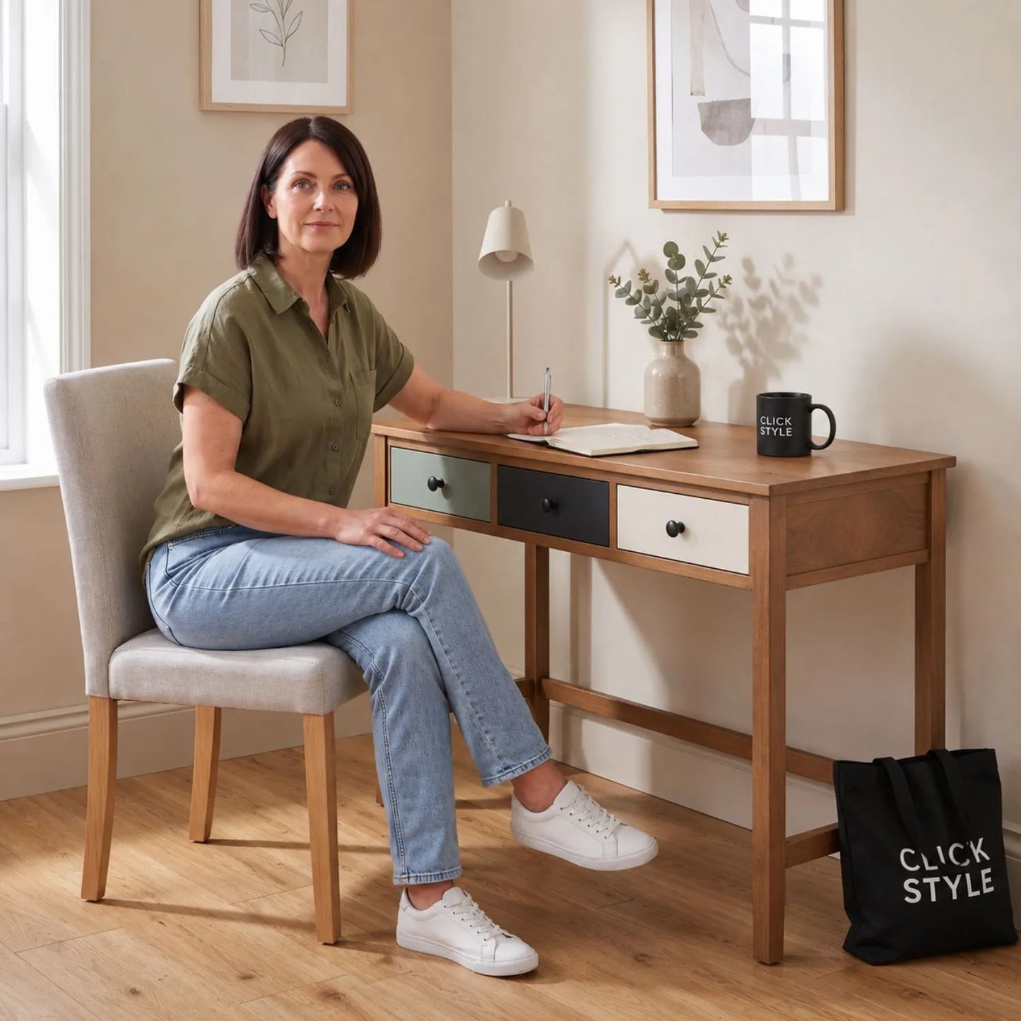 Sage Green & Neutral Pine Wood 3 Drawer Desk with Black Knob Handles styled as a home office desk with woman seated writing | Click Style