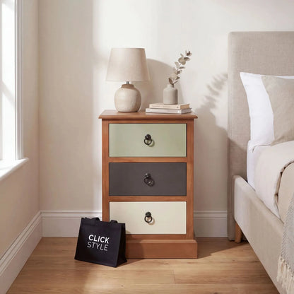 Sage green and neutral pine wood 3 drawer side table and bedside table with black ring handles styled beside a neutral bed | Click Style