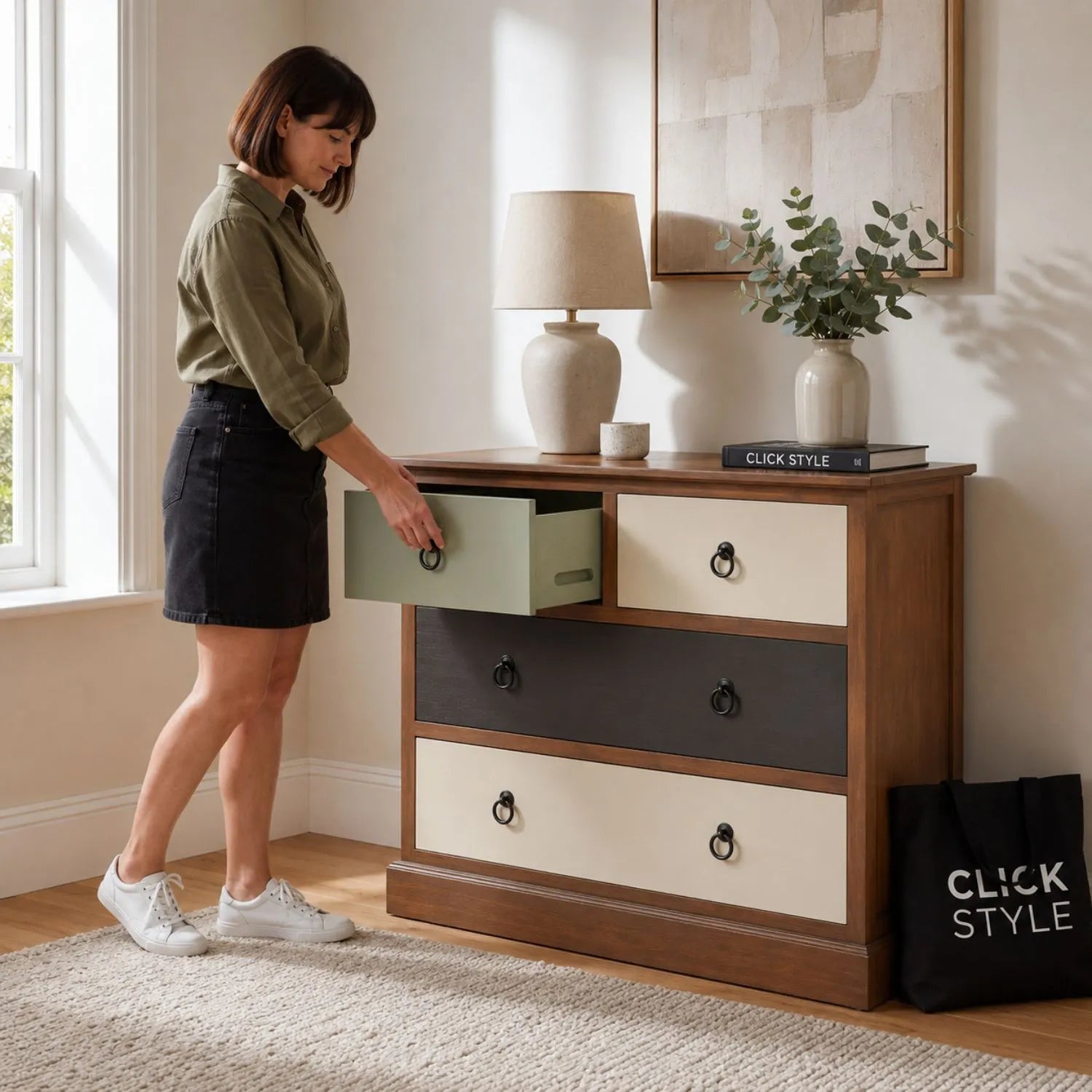Sage Green & Neutral Pine Wood 4 Drawer Chest with Black Ring Handles with woman opening the sage green drawer | Click Style
