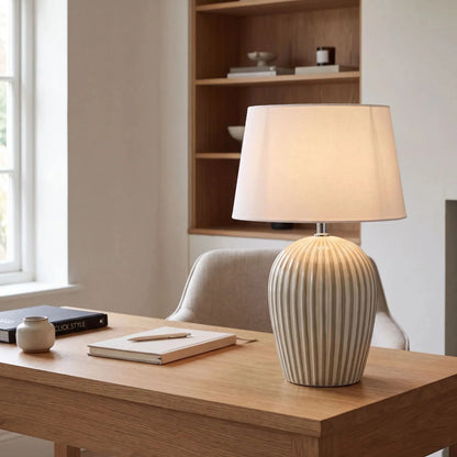 Sage Green & White Striped Ceramic Table Lamp with White Cotton Tapered Shade – Ribbed Bulbous Base Bedside Light 45x30x30cm styled with light on on a natural wood desk in a contemporary home office | Click Style