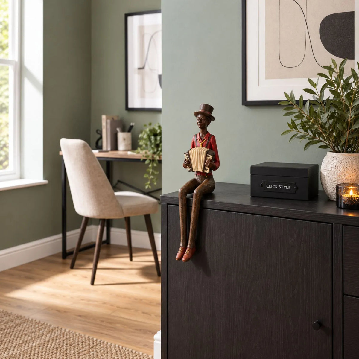 Shelf-Sitter Jazz Accordionist Resin Ornament – Sitting Musician Sculpture 40x12x10cm Styled on Dark Wood Sideboard in Contemporary Sage Green Home Study | Click Style