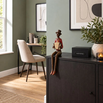 Shelf-Sitter Jazz Accordionist Resin Ornament – Sitting Musician Sculpture 40x12x10cm Styled on Dark Wood Sideboard in Contemporary Sage Green Home Study | Click Style