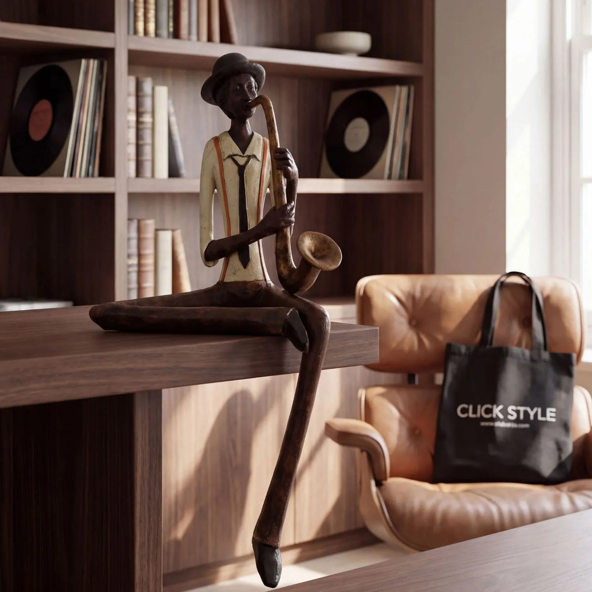 Shelf-Sitter Jazz Saxophonist Resin Ornament styled on dark wood shelving in a warm home study | Click Style