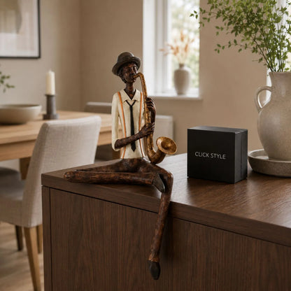 Shelf-Sitter Jazz Saxophonist Resin Ornament styled on a dark wood sideboard in a warm neutral dining room | Click Style