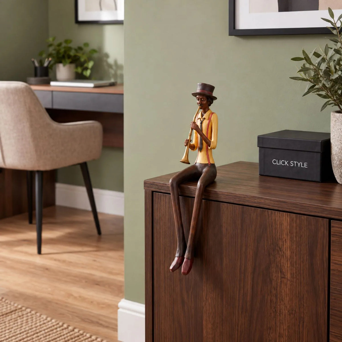 Shelf-Sitter Jazz Trumpeter Resin Ornament – Sitting Musician Sculpture Styled on Dark Wood Cabinet in Contemporary Sage Green Home Study 39x12x10cm | Click Style