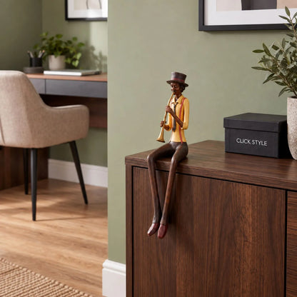 Shelf-Sitter Jazz Trumpeter Resin Ornament – Sitting Musician Sculpture Styled on Dark Wood Cabinet in Contemporary Sage Green Home Study 39x12x10cm | Click Style