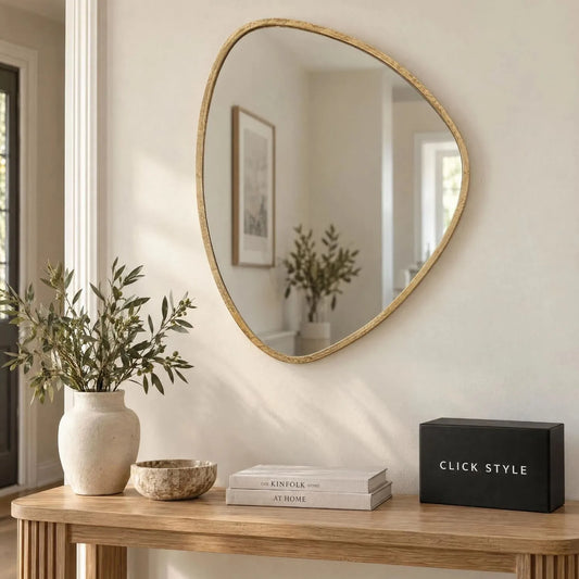 Small Antique Gold Pebble Shaped Wall Mirror with Irregular Curved Edges & Textured Metal Frame – Decorative Organic Mirror 70x60x2.5cm displayed above a light oak console table in a neutral hallway with greenery and black CLICK STYLE branding box | Click Style