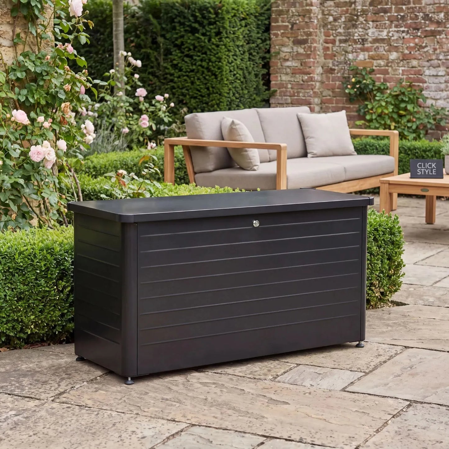 Small Black Galvanised Steel Outdoor Cushion Storage Box with Lockable Lid styled in a contemporary British garden 78x134x62cm | Click Style