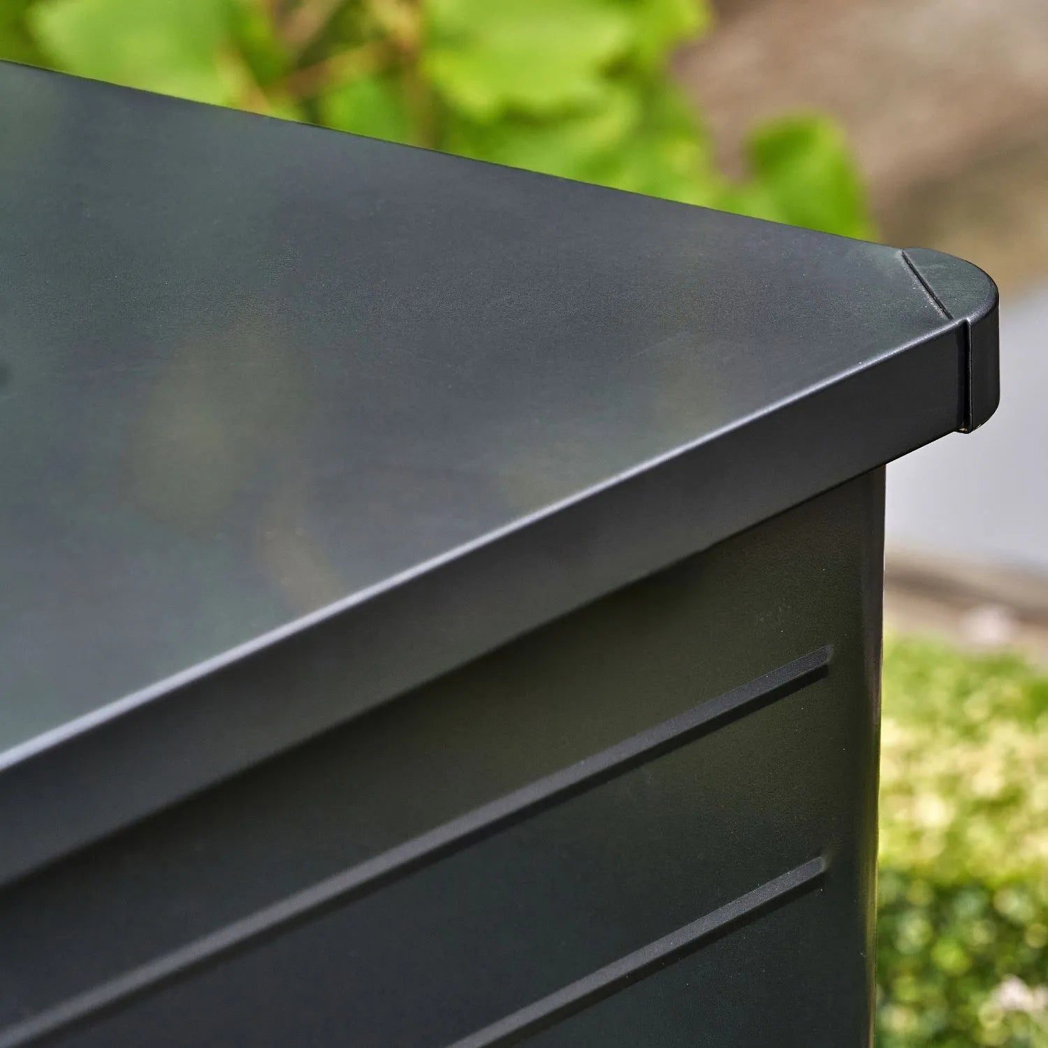 Small Black Galvanised Steel Outdoor Cushion Storage Box close-up with closed lid showing rounded top right corner front panel and lid | Click Style