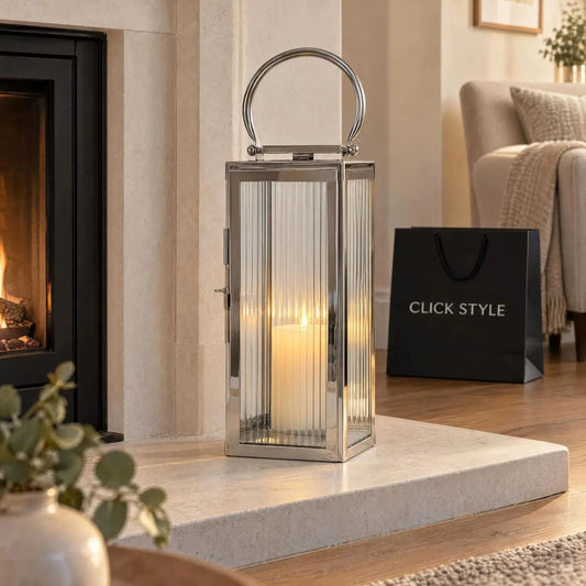 Small Polished Silver Nickel Candle Lantern with Ribbed Glass Panels & Curved Carry Handle – Decorative Stainless Steel Lantern 43x19x17cm styled on a pale limestone fireplace hearth with a glowing ivory candle in an elegant neutral living room | Click Style