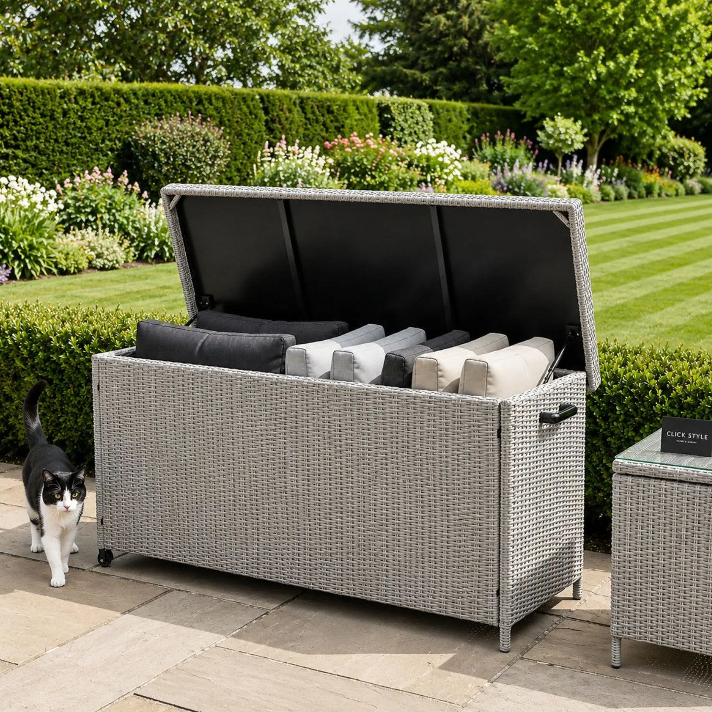 Small Slate Grey Rattan Effect 460L Weatherproof Outdoor Garden Cushion Storage Box with Wheels, Gas-Assisted Lid, UV-Protected PE Rattan and Powder-Coated Aluminium Frame | Click Style