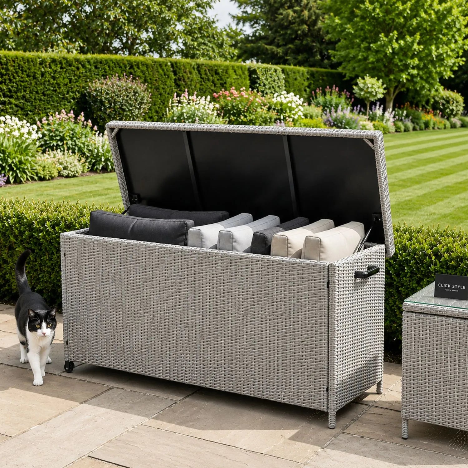 Small Slate Grey Rattan Effect 460L Weatherproof Outdoor Garden Cushion Storage Box with Wheels, Gas-Assisted Lid, UV-Protected PE Rattan and Powder-Coated Aluminium Frame | Click Style