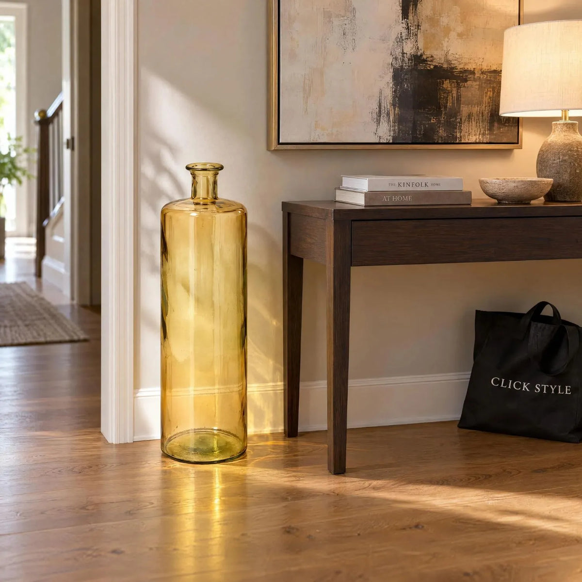 Tall Amber Yellow Recycled Glass Bottle Vase with Narrow Neck – Large Decorative Floor Standing Vase 75x25x25cm – Displayed Empty Beside Dark Wood Console Table | Click Style