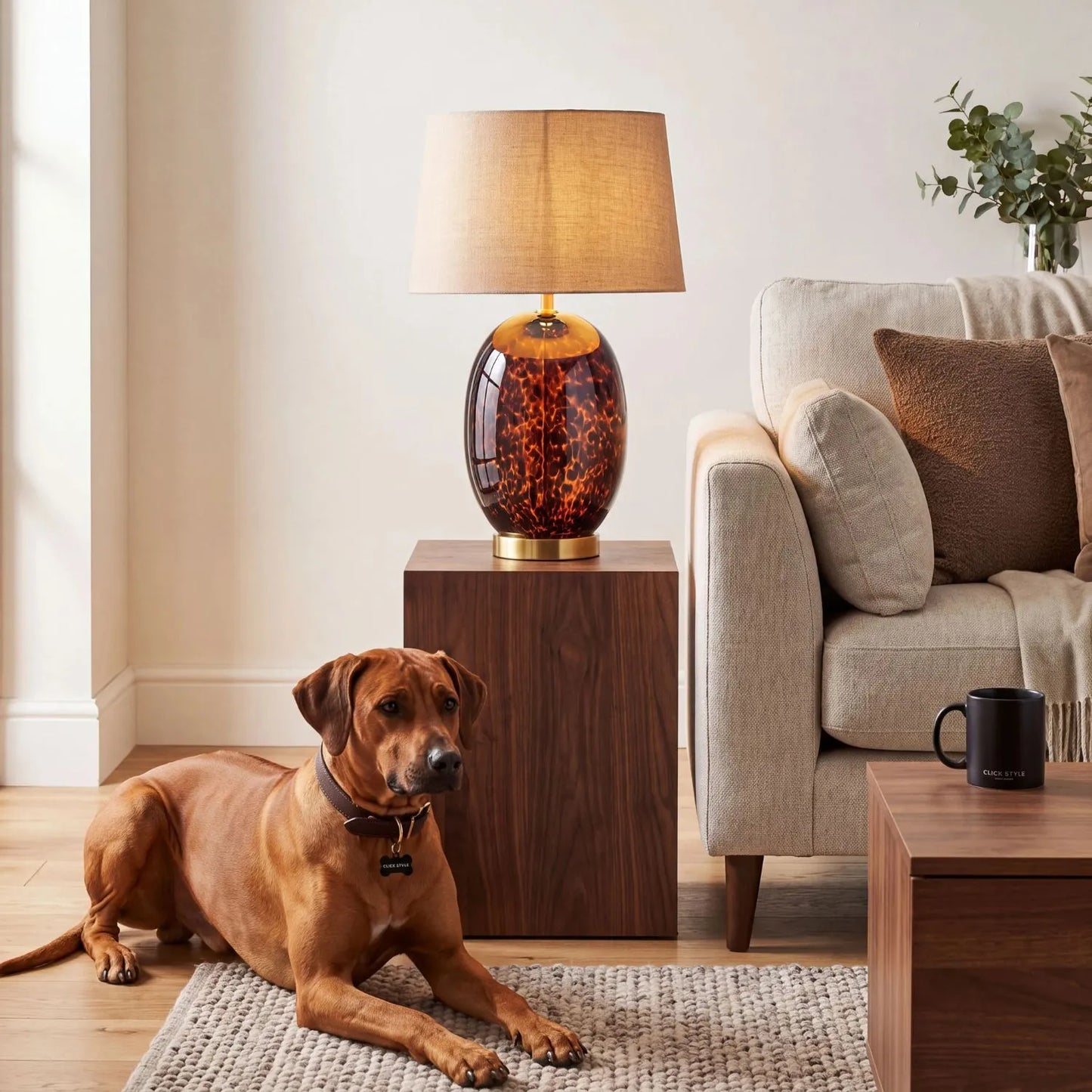 Tall Amber & Brown Tortoiseshell Glass Table Lamp with Natural Linen Tapered Shade styled in a contemporary living room with a Rhodesian Ridgeback 52x33x33cm | Click Style