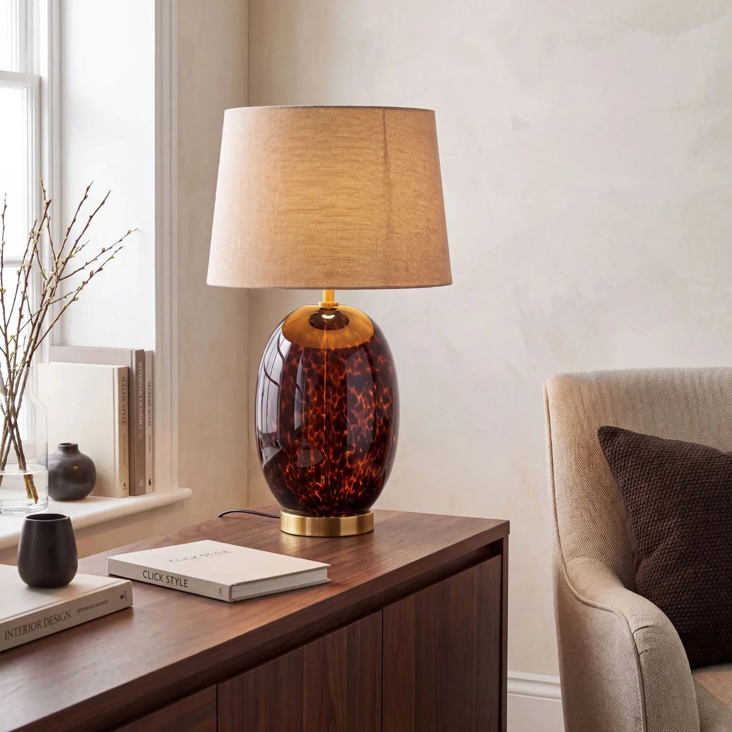 Tall Amber & Brown Tortoiseshell Glass Table Lamp with Natural Linen Tapered Shade styled on a dark walnut sideboard with subtle Click Style branding 52x33x33cm | Click Style