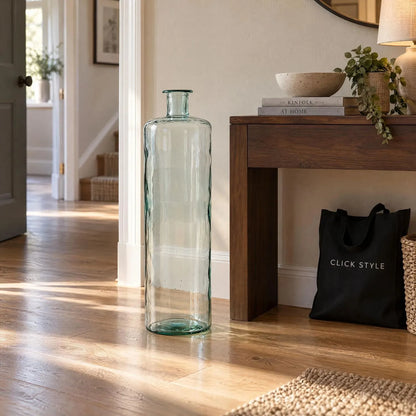 Tall Clear Recycled Glass Bottle Vase with Narrow Neck – Large Decorative Floor Standing Vase 75x25x25cm – Displayed Empty Beside a Dark Wood Console Table | Click Style