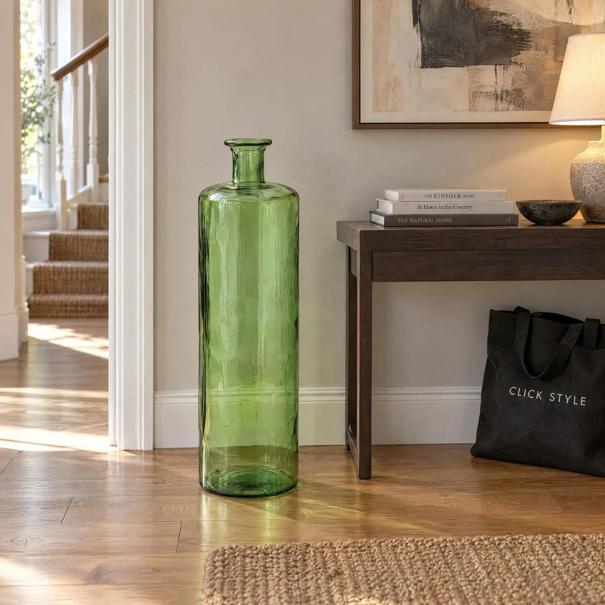 Tall Forest Green Recycled Glass Bottle Vase with Narrow Neck – Large Decorative Floor Standing Vase 75x25x25cm – Displayed Empty Beside Dark Wood Console Table | Click Style