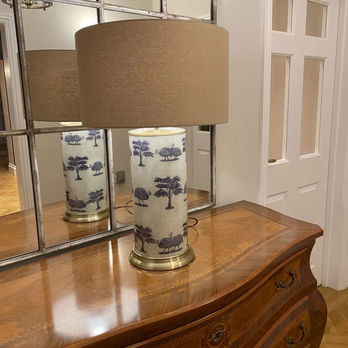 Tall Guinea Fowl Cream Champagne & Gold Glass Table Lamp with 40cm Beige Taupe Handloom Drum Shade – Handcrafted Cylindrical Statement Lighting 63x40x40cm – 5-star customer photograph showing decorative guinea fowl glass base on polished wooden chest of drawers beside large panelled mirror | Click Style