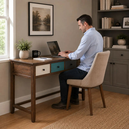 Turquoise blue and neutral distressed pine wood 3 drawer desk with black knob handles styled in a home office with man working | Click Style