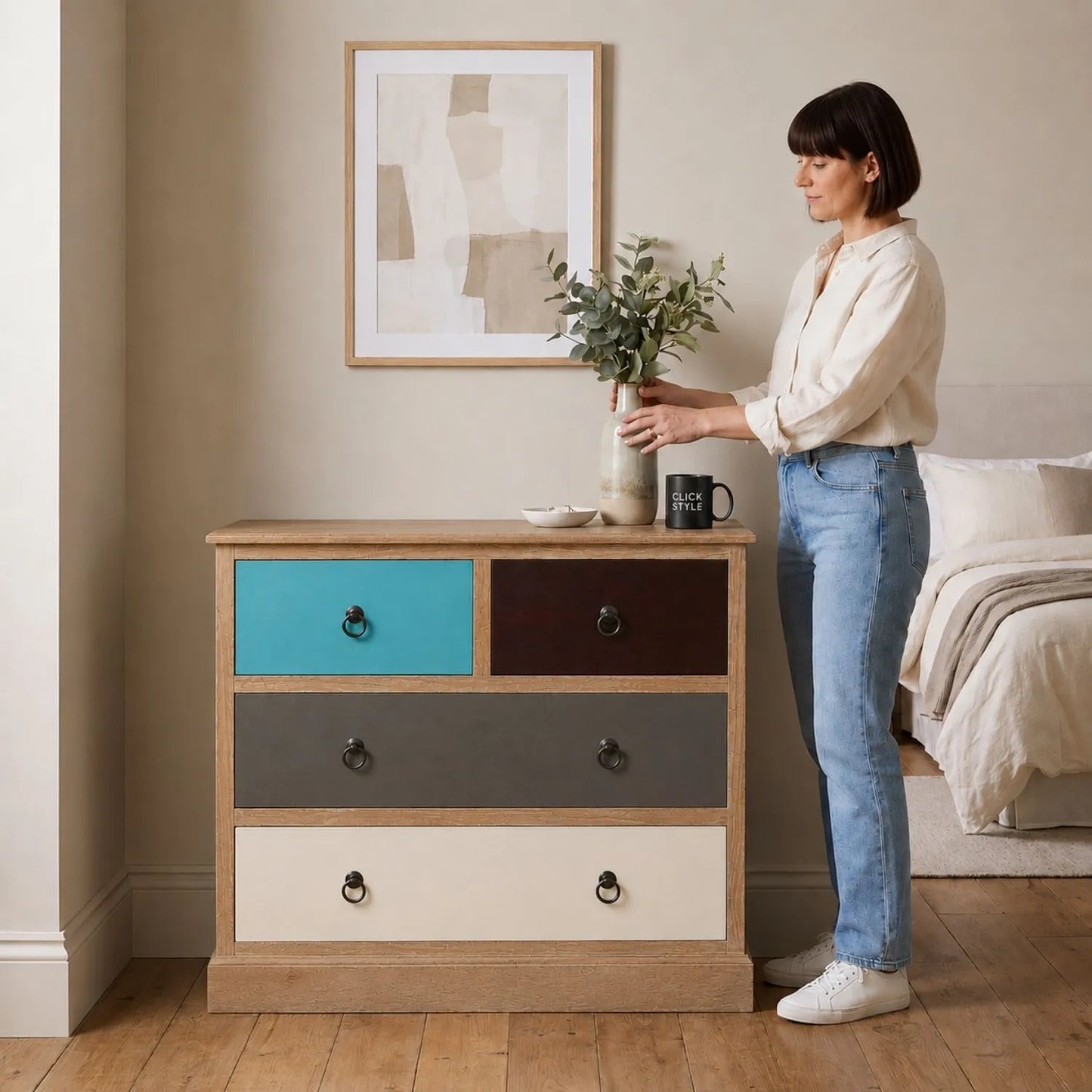 Turquoise Blue & Neutral Distressed Pine Wood 4 Drawer Chest with Black Ring Handles styled in a neutral bedroom with woman | Click Style