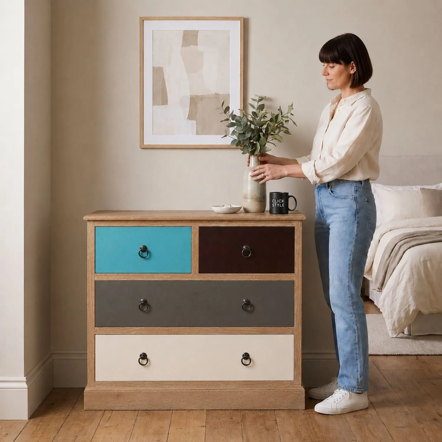 Turquoise Blue & Neutral Distressed Pine Wood 4 Drawer Chest with Black Ring Handles styled in a neutral bedroom with woman | Click Style