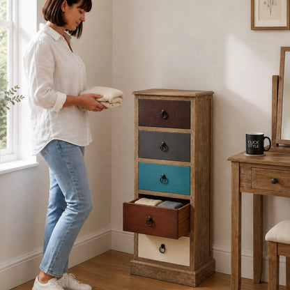 Turquoise blue and neutral distressed pine wood 5 drawer tallboy chest with black ring handles styled in a bedroom with woman | Click Style