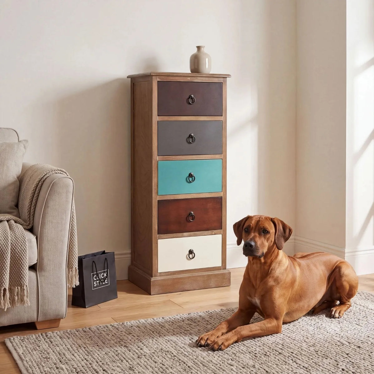 Turquoise blue and neutral distressed pine wood 5 drawer tallboy chest with black ring handles styled in a neutral living room with Rhodesian Ridgeback | Click Style