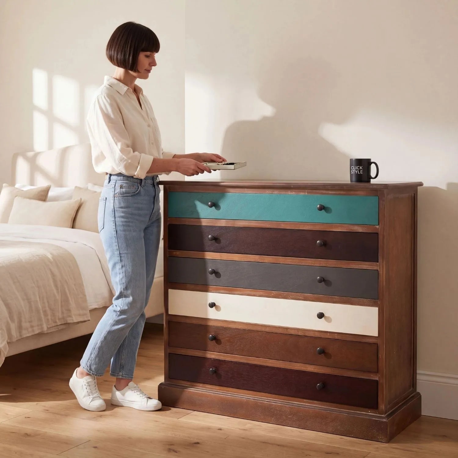 Turquoise blue and neutral distressed pine wood 6 drawer chest with black knob handles styled in a bedroom with woman | Click Style