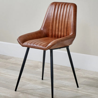 Vintage brown genuine leather dining chair with channel-stitched ribbed upholstery and interchangeable black and bronze metal legs | Click Style