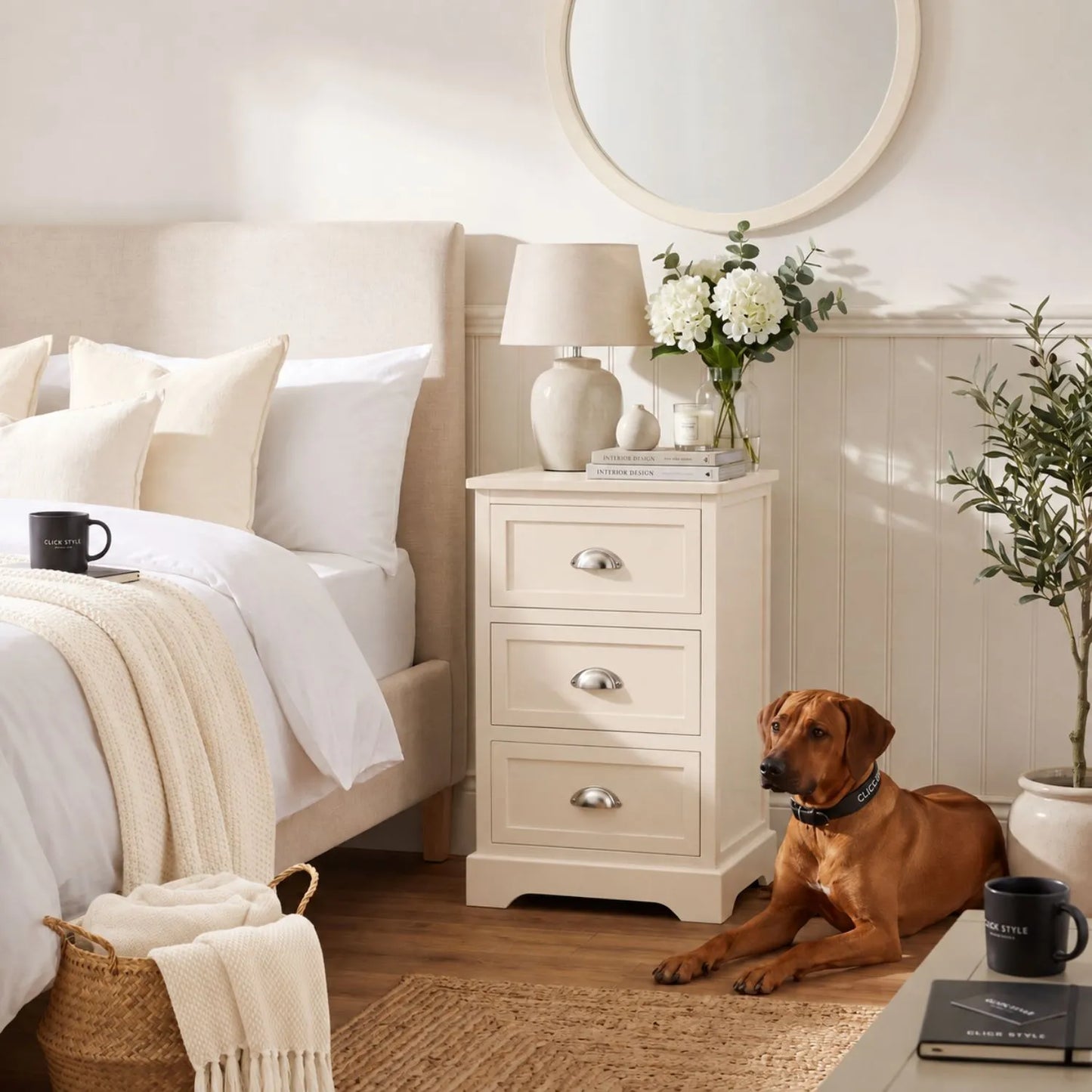 Warm Ivory Pine Wood 3 Drawer Chest of Drawers with Polished Silver Cup Handles styled as a bedside cabinet with neutral bedroom decor and Rhodesian Ridgeback 70x41x33cm | Click Style