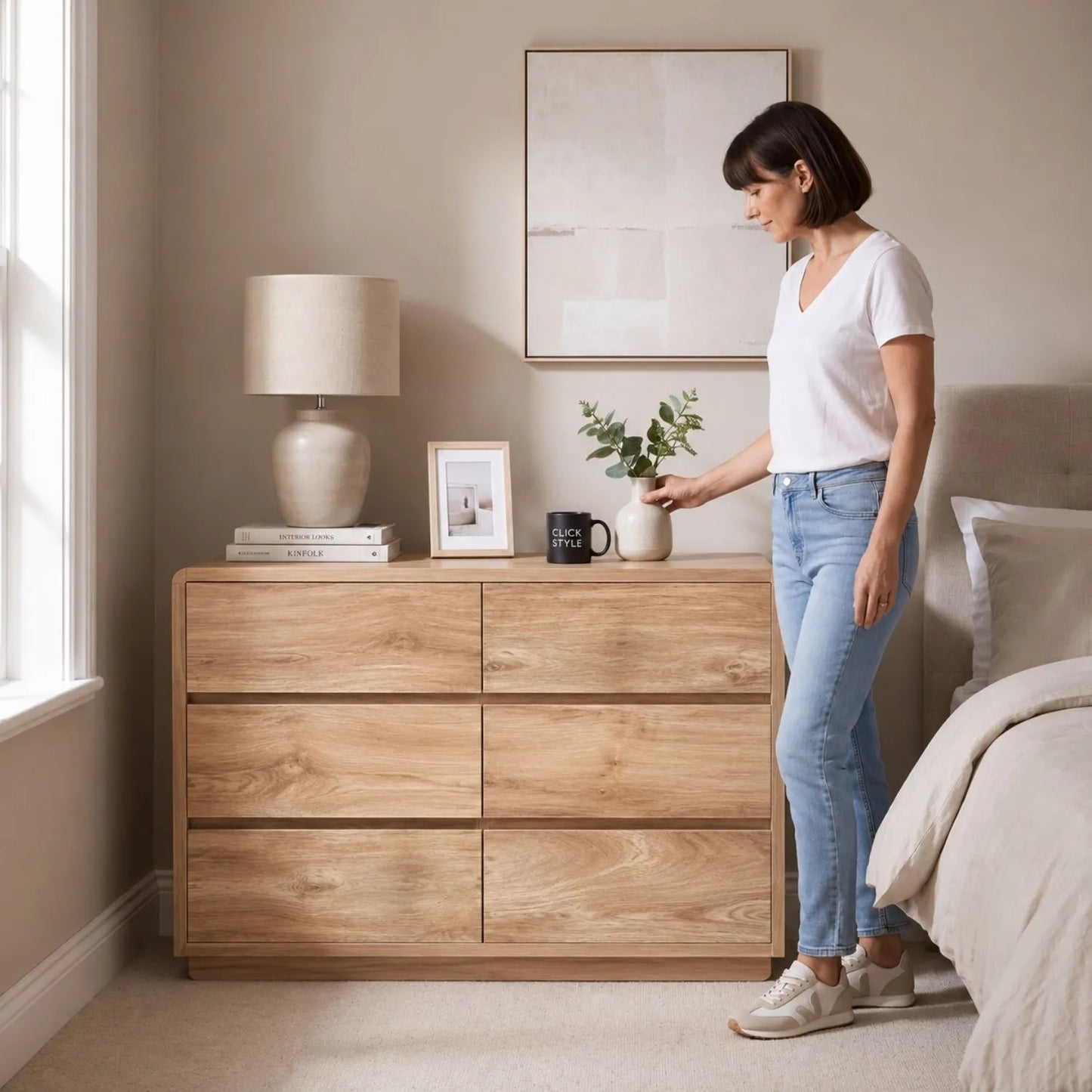 Warm Natural Oak Effect Handleless 6 Drawer Chest of Drawers styled with woman in a neutral bedroom | Click Style