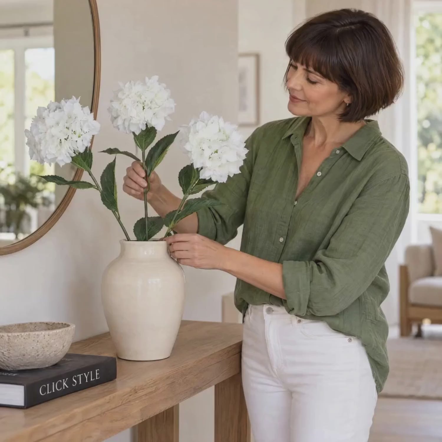 Artificial White Schneeball Hydrangea with Long Stem & Compact Bloom – Realistic Faux Hydrangea Flower with Green Foliage 71cm – Woman Gently Arranging White Hydrangea Stems in Cream Ceramic Vase | Click Style