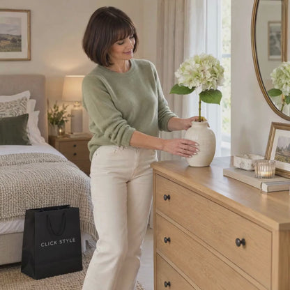 Artificial Pale Green Hydrangea Stem with Multi-Tonal Petals & Realistic Green Leaves – Lifelike Faux Green Hydrangea Flower 50x30x30cm – Lifestyle Video Showing a Woman Gently Adjusting the Hydrangea Petals in a Cream Ceramic Vase on an Oak Chest of Drawers | Click Style