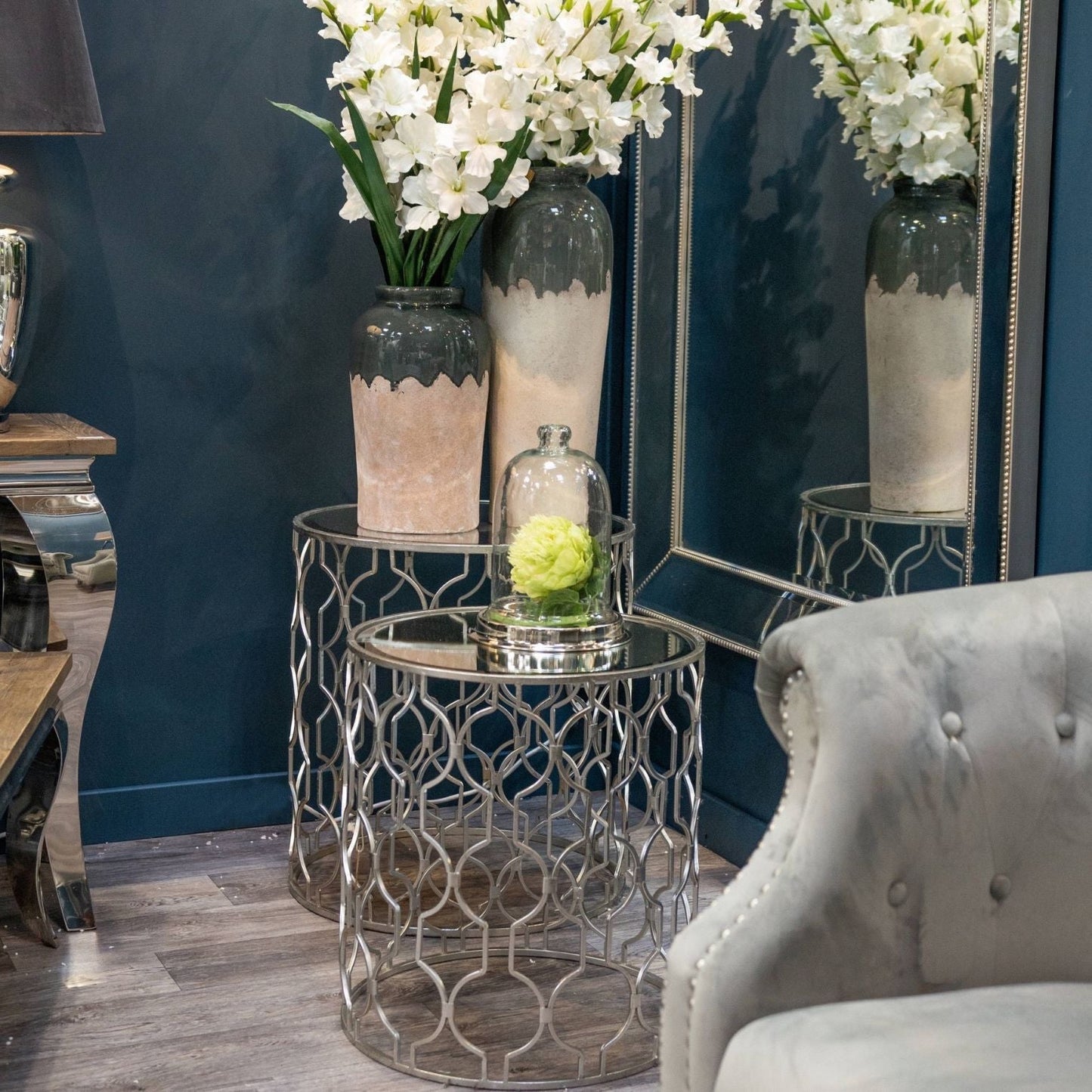 Pair of silver side tables with an ornate frame